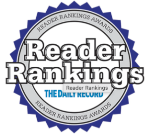 Screenshot 2026-08-21 at 105956 AM - HWK Law Group Circular award badge with a blue scalloped edge, prominent 'Reader Rankings' text across the center and 'Reader Rankings Awards' around the rim with 'The Daily Record' logo in blue.